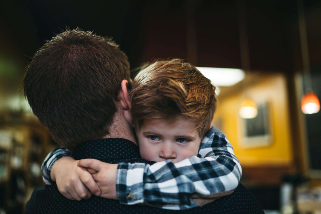 son embracing father hug
